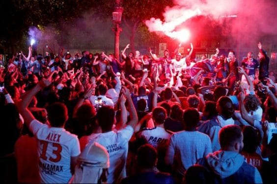 Soccer Football - Champions League - Semi Final - Paris St Germain fans celebrate after their Champions League Semi Final match against RB Leipzig - Paris, France - August 18, 2020 Paris St Germain fans celebrate on the Champs-Elysees after the match REUTERS/Charles Platiau TPX IMAGES OF THE DAY